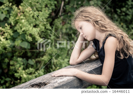 Portrait of sad blond teen girl sitting on the bridge Portrait of sad blond teen girl sitting on the bridge 16446011