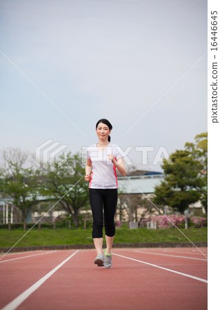 A young lady running in the stadium 16446645