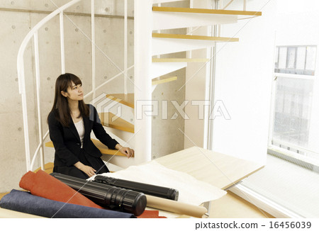 A woman resting on a spiral staircase 16456039