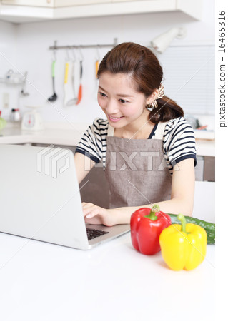 A housewife looking for recipes online 16465316