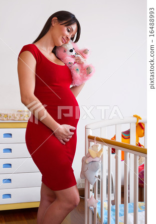 pregnant woman near baby cot 16488993