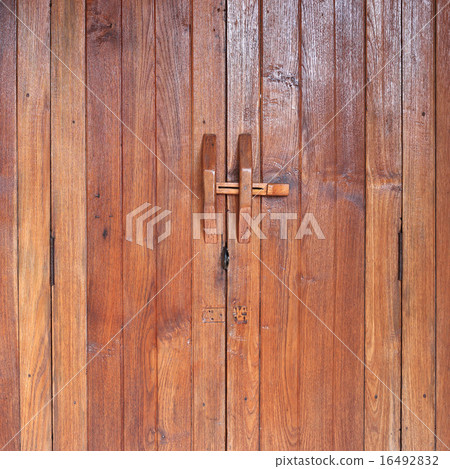 Door handle on brown wood door 16492832