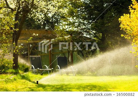 Gardening. Lawn sprinkler spraying water over grass. Gardening. Lawn sprinkler spraying water over grass. 16500882