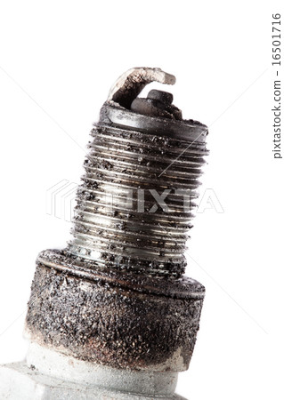 Auto service. Old spark plug as spare part of car. 16501716