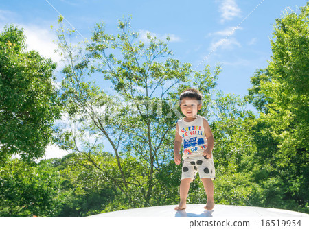 A boy with a smile playing in the park A boy with a smile playing in the park 16519954