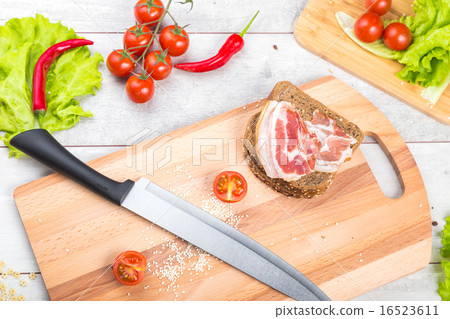 Tomato, toasts, meat and salad on wooden table Tomato, toasts, meat and salad on wooden table 16523611