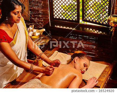Woman having Ayurvedic spa treatment. 16524920