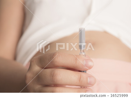 Pregnant woman with syringe in hand ( Filtered image processed v 16525999
