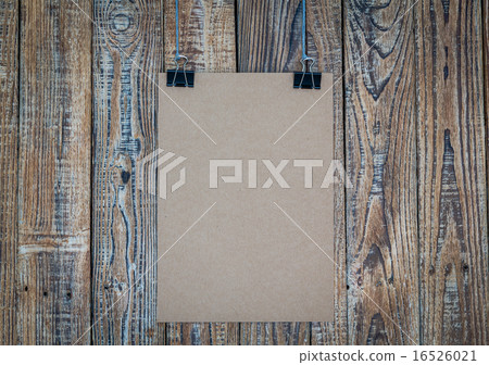 Black clip and White paper hang on wood background Black clip and White paper hang on wood background 16526021
