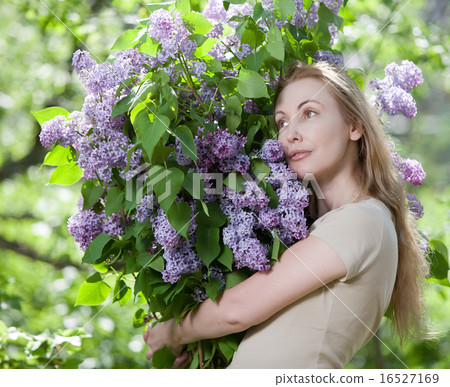 woman in park with a big bouquet of a lilac woman in park with a big bouquet of a lilac 16527169