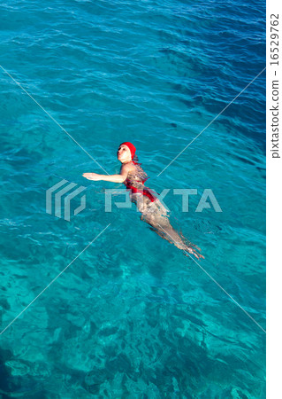 The sports girl swims in the sea 16529762