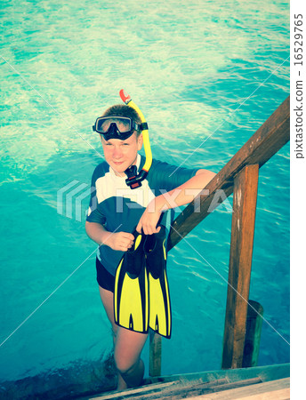 teenager with flippers, mask and tube at ocean. .M 16529765