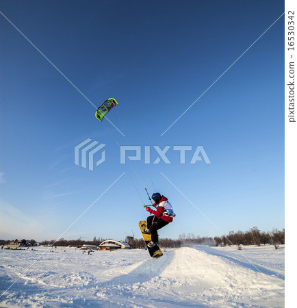 Kiteboarder with kite on the snow 16530342