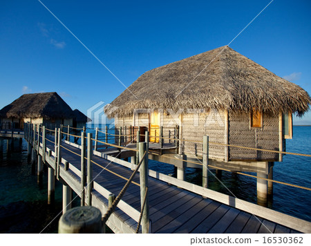 Typical Polynesian landscape -small houses on wate Typical Polynesian landscape -small houses on wate 16530362