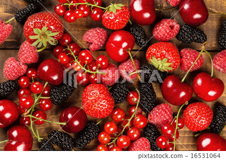 Collection of berries on wood background 16531064