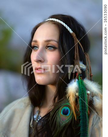 Attractive young woman and feather headpiece 16533090
