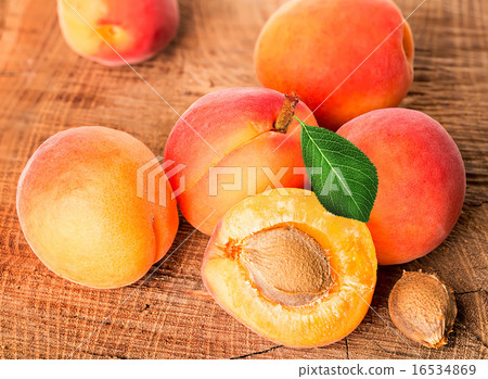 Apricots on the wooden background Apricots on the wooden background 16534869