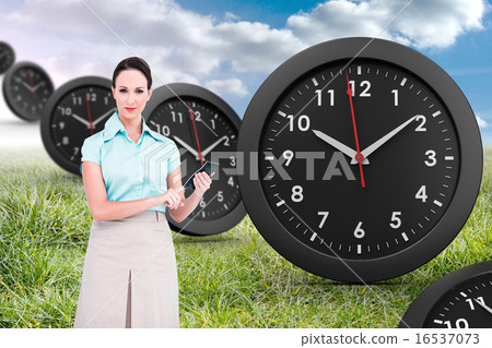 Composite image of serious classy businesswoman using calculator Composite image of serious classy businesswoman using calculator 16537073