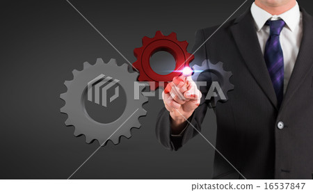 Composite image of businessman standing and pointing 16537847