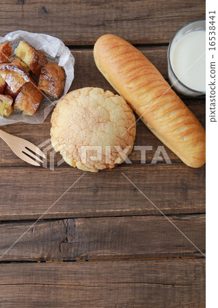 Several kinds of sweet bread and a glass of milk 16538441