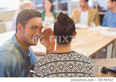 Casual businessman whispering secret to his colleague Casual businessman whispering secret to his colleague 16540432