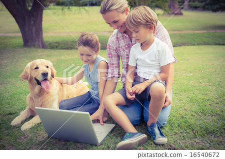 Happy family with their dog using laptop Happy family with their dog using laptop 16540672