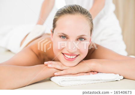 Peaceful blonde enjoying an exfoliating back massage Peaceful blonde enjoying an exfoliating back massage 16540673