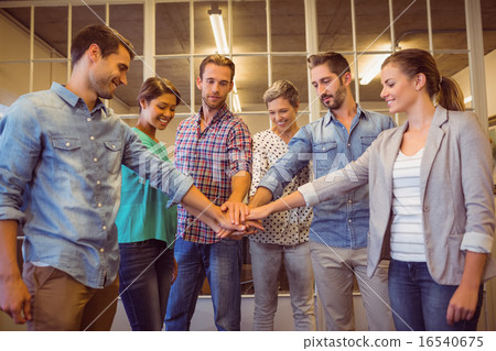 Creative business team putting their hands together 16540675