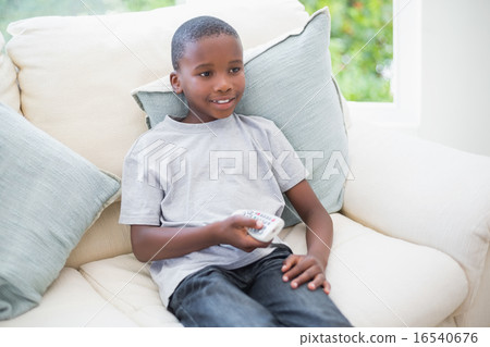 Little boy watching tv on the couch Little boy watching tv on the couch 16540676