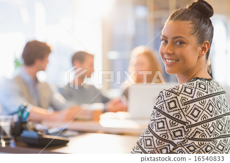 Portrait of smiling young businesswoman with colleagues 16540833