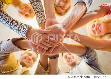 Happy business team joining their hands 16541342