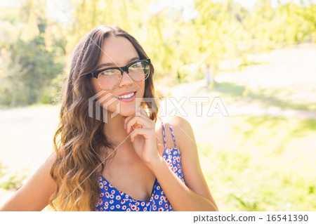 Pretty brunette smiling at camera 16541390