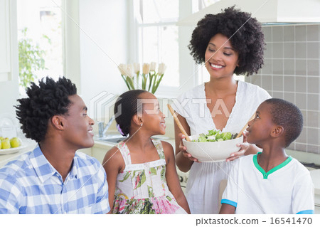 Stock Photo: Happy family sitting down to dinner together