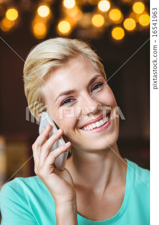Pretty blonde woman using her smartphone Pretty blonde woman using her smartphone 16541963