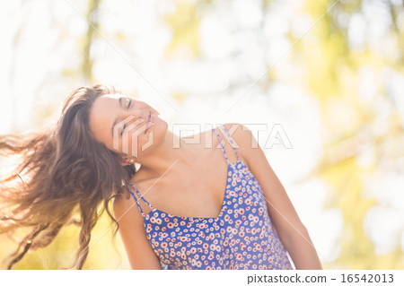 Pretty brunette tossing her hairs Pretty brunette tossing her hairs 16542013