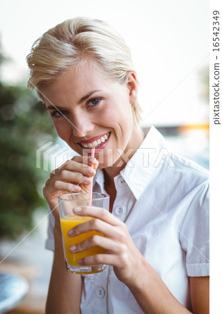 Young woman having glass of orange juice 16542349