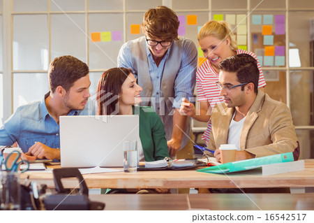 Happy creative business team using laptop in meeting Happy creative business team using laptop in meeting 16542517