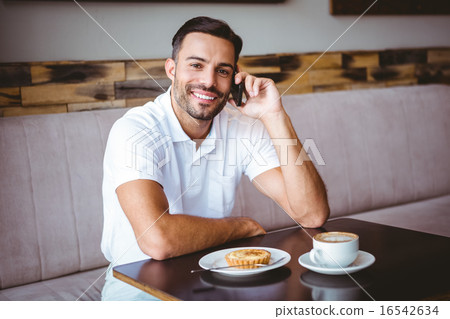 Young man smiling on the phone Young man smiling on the phone 16542634