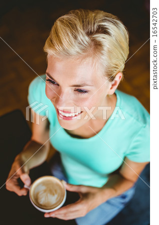 Pretty blonde holding cup of coffee 16542703