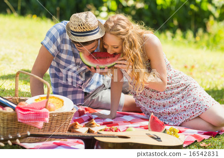 Young couple on a picnic eating watermelon 16542831