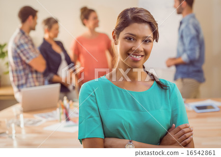 Young casual businesswoman smiling at camera 16542861