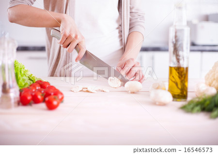 Woman cutting mushrooms Woman cutting mushrooms 16546573
