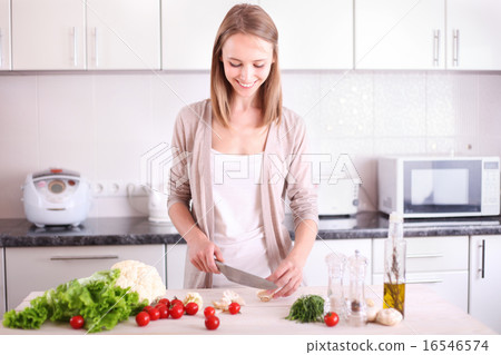 Young Woman Cooking in the kitchen. 16546574