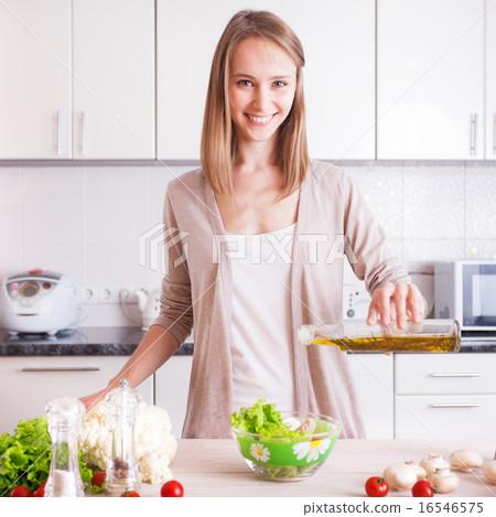 Young Woman Cooking in the kitchen. Young Woman Cooking in the kitchen. 16546575