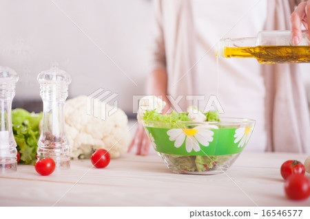 Young woman mixing fresh salad. Young woman mixing fresh salad. 16546577