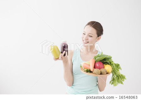A woman with vegetable juice A woman with vegetable juice 16548063