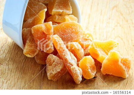 Closeup candied dried ginger in white bowl Closeup candied dried ginger in white bowl 16556314