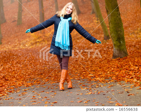 girl relaxing walking in autumnal park, outdoor 16556638