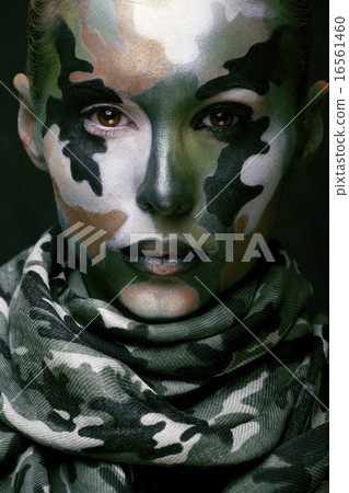 Beautiful young fashion woman with military style clothing and face paint make-up, khaki colors 16561460