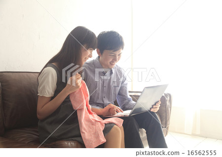 Image of married couple purchasing baby goods through internet mail order 16562555